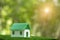 Environmentally eco-friendly real estate house. Small model building property home on grass in green nature ecology. Sustainable