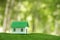 Environmentally eco-friendly real estate house. Small model building property home on grass in green nature ecology. Sustainable