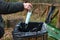 Environmentally friendly person throws a protective mask in the garbage can during the coronavirus pandemic. Concept for pollution