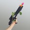 Environmentally issue protest inspired concept. Man hand hold futuristic rifle with nice gentle rose around it high in the air.