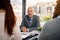 Envisioning greatness together. Portrait of a mature businessman sitting in an office with colleagues.