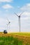 Eolian wind turbine with plough tractor in the background