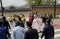 eople cross the street at a pedestrian crossing.