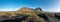 Epic aerial drone view flying over landscape of the black sand beach in Stokksnes on a sunny day.