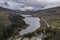 Epic aerial flying drone landscape image of Snowdon Massif viewed from above Llynau Mymber during Autumn sunset with dramatic sky