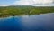 Epic aerial top down of crystal clear coral reefs under wooden pier on Gili Meno Island during sunshine