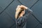 Epic back view of strong fit female athlete getting ready for workout towards the sun. Strong fitness woman tying ponytail. Motiva