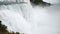 Epic close-up shot of powerful raging flows of water and spray rushing down at beautitul Niagara Falls slow motion.