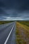 Epic cloudy landscape of an empty highway through the tundra of  Norway