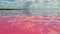 Epic colorful aerial footage from drone flight over pink salt lake
