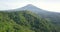 Epic drone flight showing tropical forest trees and Mount Sumbing