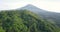 Epic drone flight showing tropical forest trees and Mount Sumbing