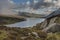 Epic early Autumn Fall landscape of view along Ogwen Valley in Snowdonia National Park under dramatic evening sky with copy space