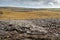 Epic landscape in Burren area, West of Ireland. Rough stone terrain with green fields. Warm sunny day, Cloudy sky. Nobody. Travel