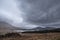 Epic landscape image of Loch Tulla in Scottish Highlands near Glencoe with dramatic stormy skies overhead