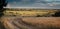 Epic landscape wheat field road haystack