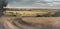 Epic landscape wheat field road haystack