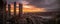 Epic panorama sunrise looking out over San Francisco with a bright orange sun shining between skyscrapers