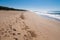 Epic seascape view with long empty beach with yellow sand and mild waves