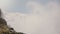 Epic slow motion close-up shot of powerful raging currents of water and spray rushing down at beautiful Niagara Falls.