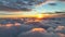 Epic sunset over the clouds. Warm sun sets over the horizon in clouds. Flight in the sky at sunset, view from window of