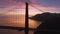 Epic sunset sky with rose golden clouds on background of Golden Gate Bridge 4K