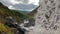 Epic view from under the waterfall to the mountain valley and river.