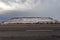 Epic wide angle shot of snow covered mesa plateau along empty highway in rural New Mexico