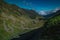 Epic winding road on Transfagarasan pass in Romania in summer time, with twisty road rising up. Road crossing Fagaras mountain