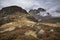 Epic Winter landscape image of view from Side Pike towards Langdale pikes with low level clouds on mountain tops and moody mist