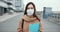 Epidemic control worker. Portrait of Caucasian social care woman in medical face mask in empty street during quarantine.