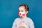 Epidemic covid-19. Frightened girl in a medical mask covered in coronavirus on a blue background