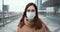 Epidemic protection. Portrait of beautiful Caucasian woman in medical face mask in empty city street during quarantine.