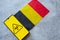 Epidemiological situation in the country Belgium. Flag and smartphone with news and a biohazard symbol.