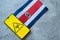 Epidemiological situation in the country costa rica. Flag and smartphone with news and a biohazard symbol.