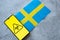 Epidemiological situation in the country Sweden. Flag and smartphone with news and a biohazard symbol.