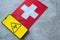 Epidemiological situation in the country Switzerland. Flag and smartphone with news and a biohazard symbol.