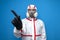 The epidemiologist in a chemical protective suit shows a finger to the side on a isolated background, man, biologist, scientist,