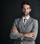 The epitome of the modern businessman. Studio portrait of a confident young businessman against a black background.