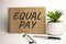 Equal Pay paper notepad on office work place