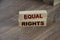 Equal rights words on wooden blocks on table . Gender equality concept