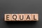 Equal - word from wooden blocks with letters