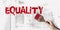 Equality word painted with paintbrush. Gender or ethnical equality concept