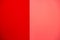 equally vertically divided smooth solid uniform bright and contemporary lifeguard red and hipster salmon stucco wall background