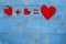 Equation with hearts arranged on blue background