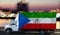 Equatorial Guinea flag on the side of a white van against the backdrop of a blurred city and river. Logistics concept