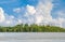 Equatorial mangroves in the sea against cloudy and blue sky back