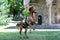 Equestrian Euphoria: Young Male Horseman Jumping on Meadow