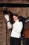 Equestrian girl with a saddle horse in winter stable