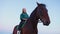 An equestrian teenage girl on horseback